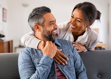 couple embracing and smiling at each other